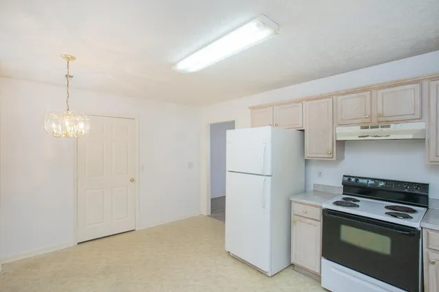a kitchen with refrigerator a stove a microwave and cabinets