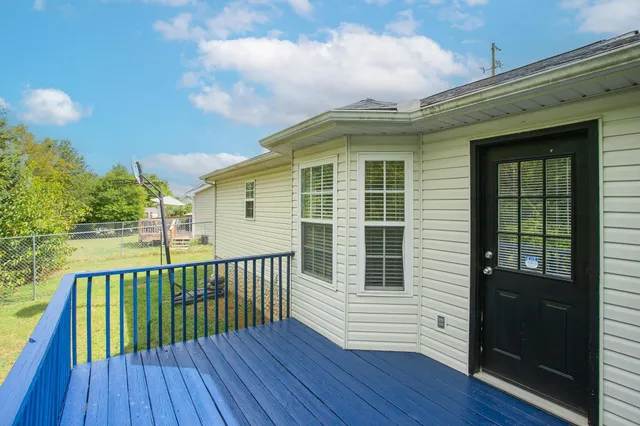 a view of a house with wooden deck