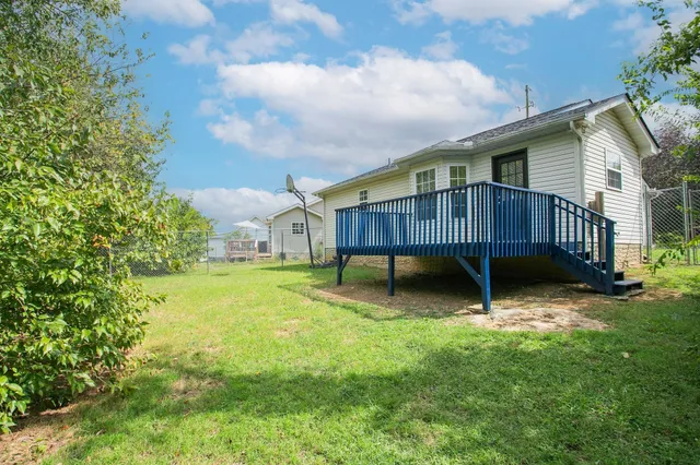a view of a house with a yard and sitting area