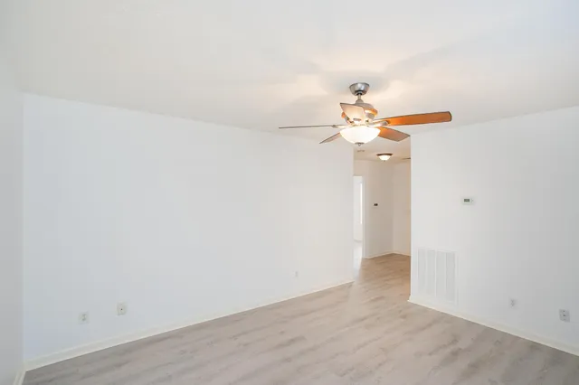 a view of a chandelier fan and hardwood floor