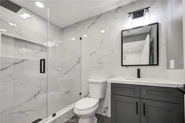 a bathroom with a toilet sink and shower