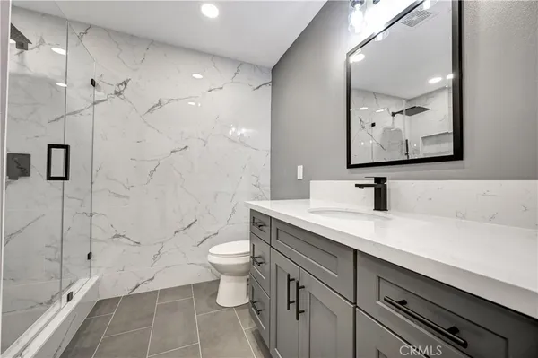 a view of bathroom with a sink mirror toilet and bathtub
