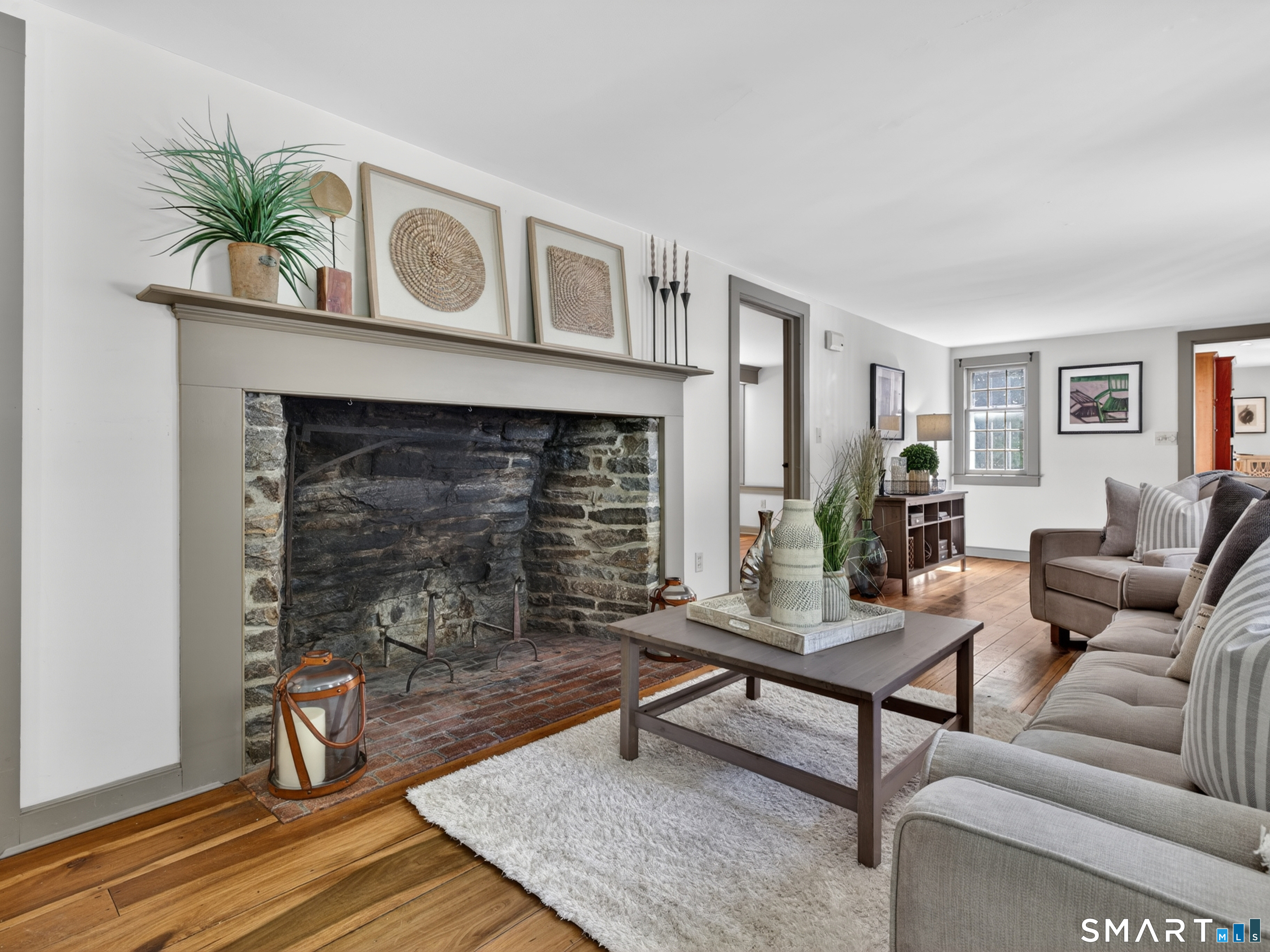 14 Cow Pen Hill Road Killingworth, CT 06419 - Photo 14 of 40 Cozy keeping room just off the kitchen, anchored by a stunning oversized fireplace that invites gathering and conversation.