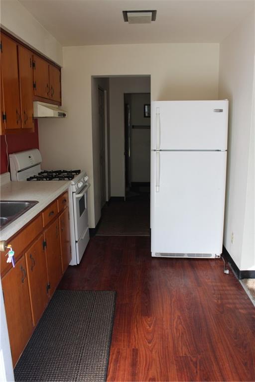 283 Freeport Road Creighton, PA 15030 - Photo 14 of 25 a kitchen with wooden floors and white appliances