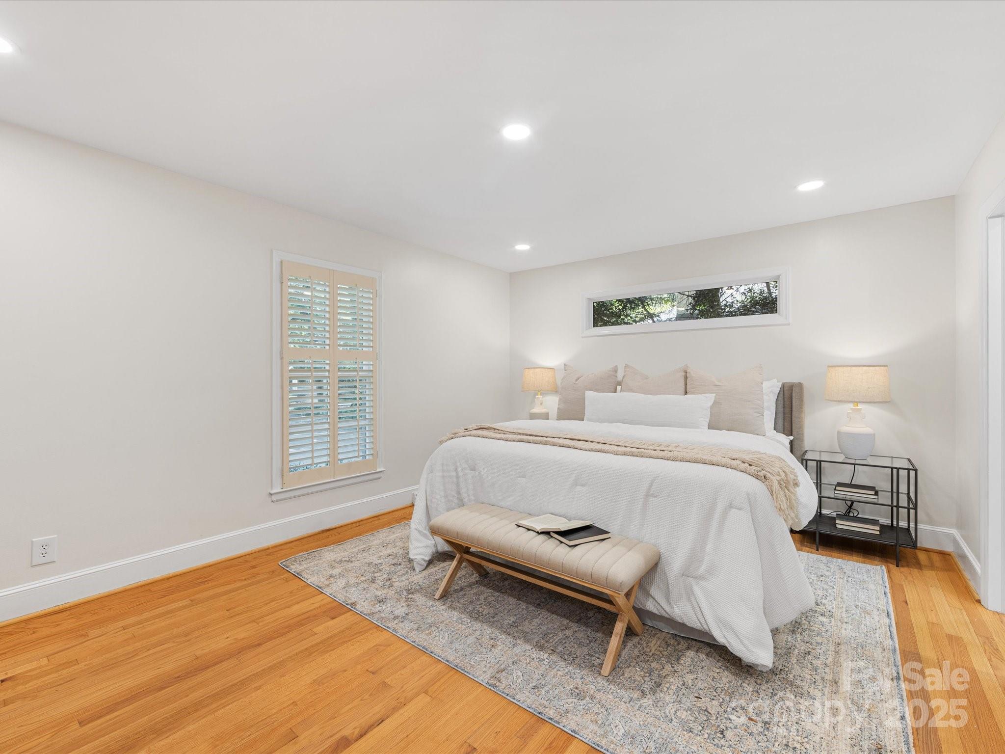 2118 Sharon Road Charlotte, NC 28207 - Photo 20 of 48 a bedroom with a bed and wooden floor