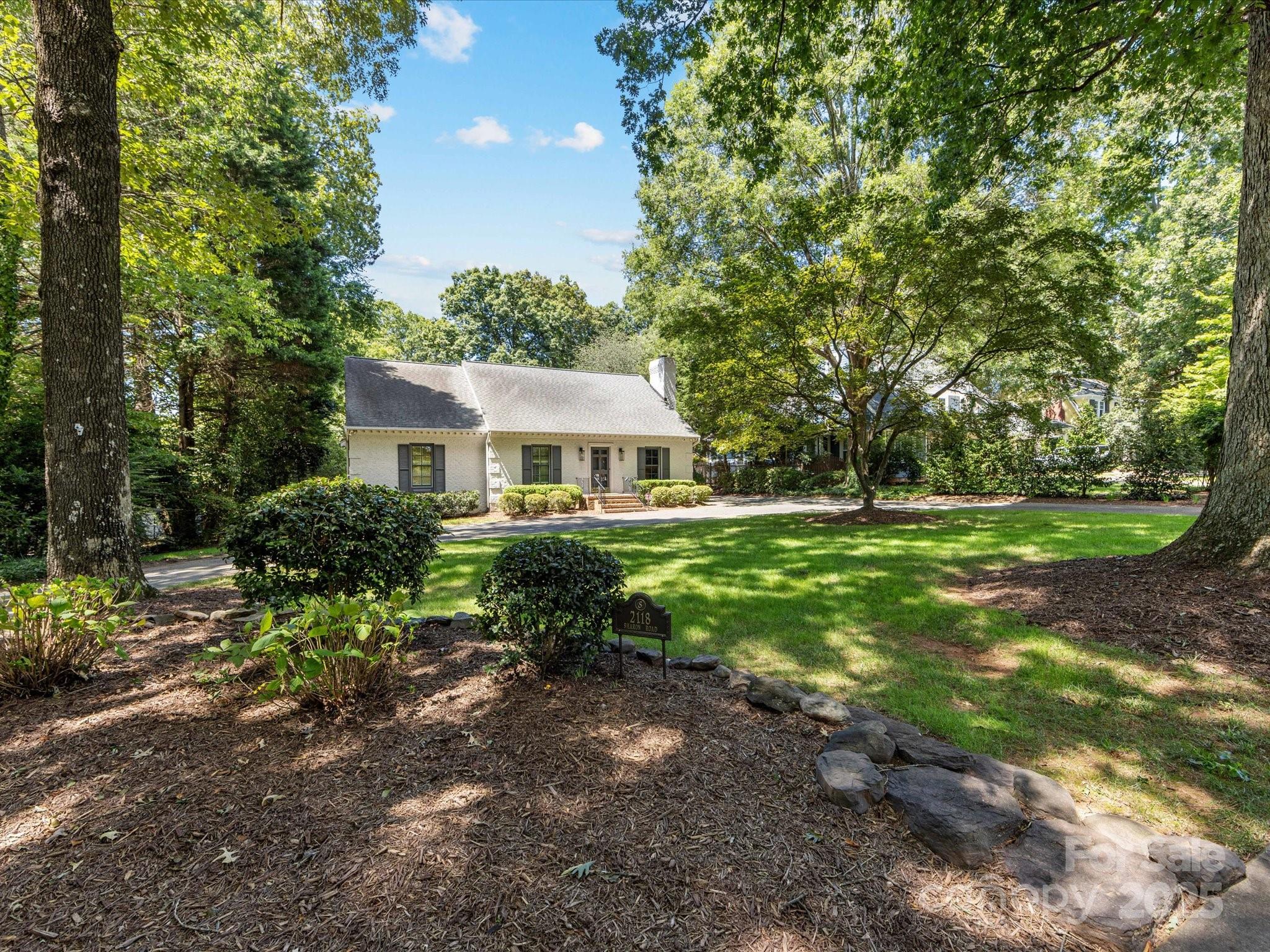 2118 Sharon Road Charlotte, NC 28207 - Photo 2 of 48 a front view of a house with yard and green space
