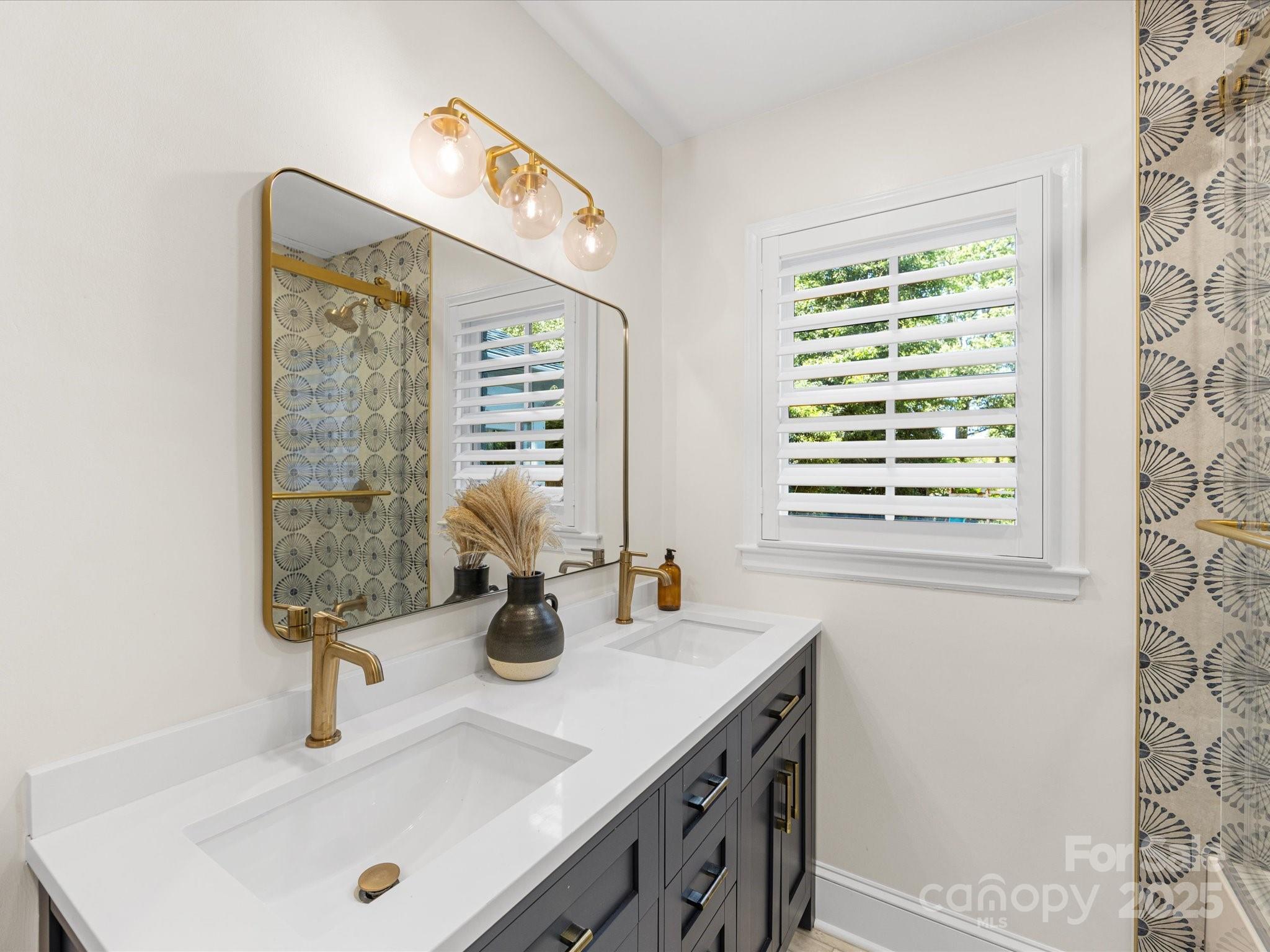 2118 Sharon Road Charlotte, NC 28207 - Photo 27 of 48 a bathroom with a sink and a mirror