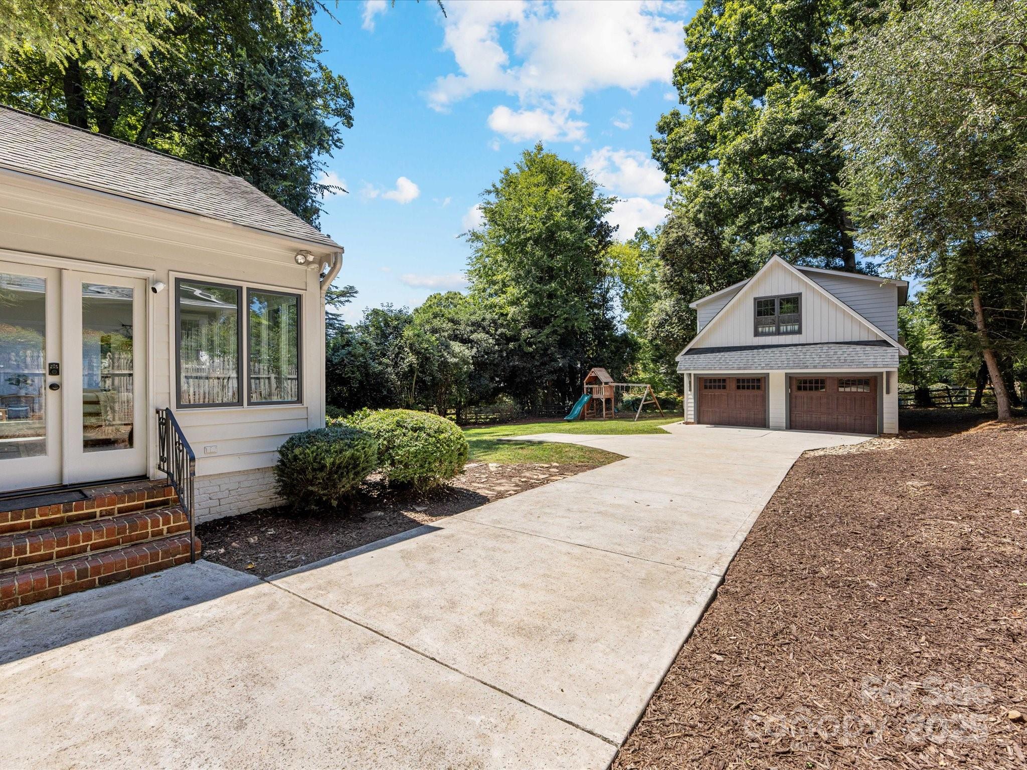2118 Sharon Road Charlotte, NC 28207 - Photo 39 of 48 a front view of a house with a garden