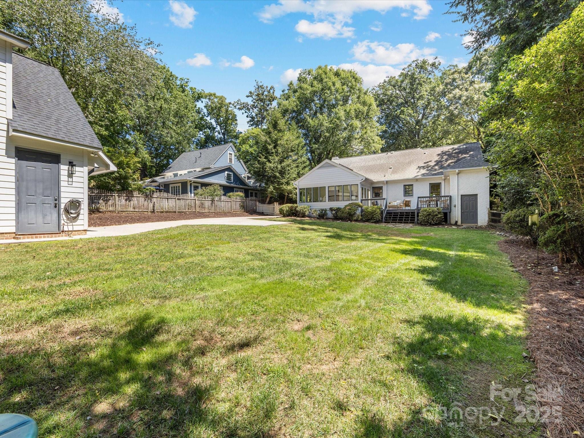 2118 Sharon Road Charlotte, NC 28207 - Photo 42 of 48 a view of a house with a big yard and large trees