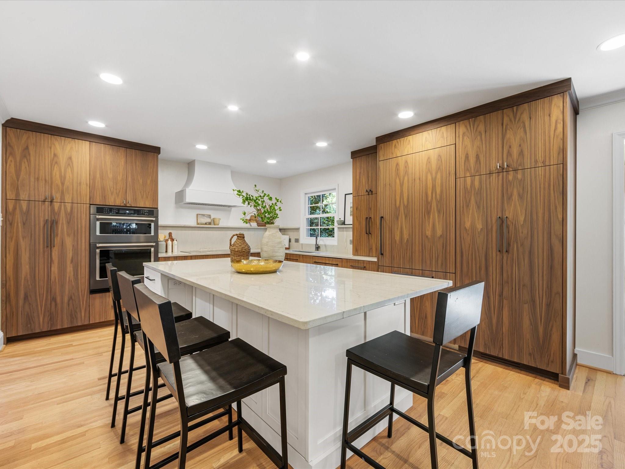 2118 Sharon Road Charlotte, NC 28207 - Photo 7 of 48 a kitchen with stainless steel appliances a table and chairs in it