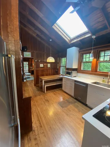 a kitchen with stainless steel appliances granite countertop a refrigerator and a stove