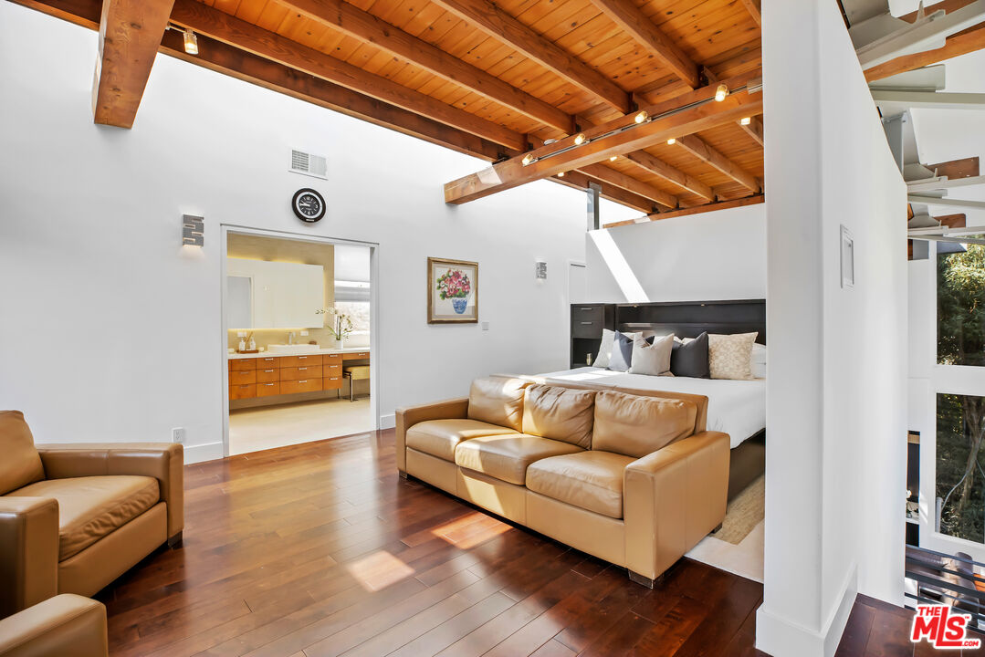 1857 North Beverly Drive Beverly Hills, CA 90210 - Photo 24 of 49 a bedroom with furniture and wooden floor