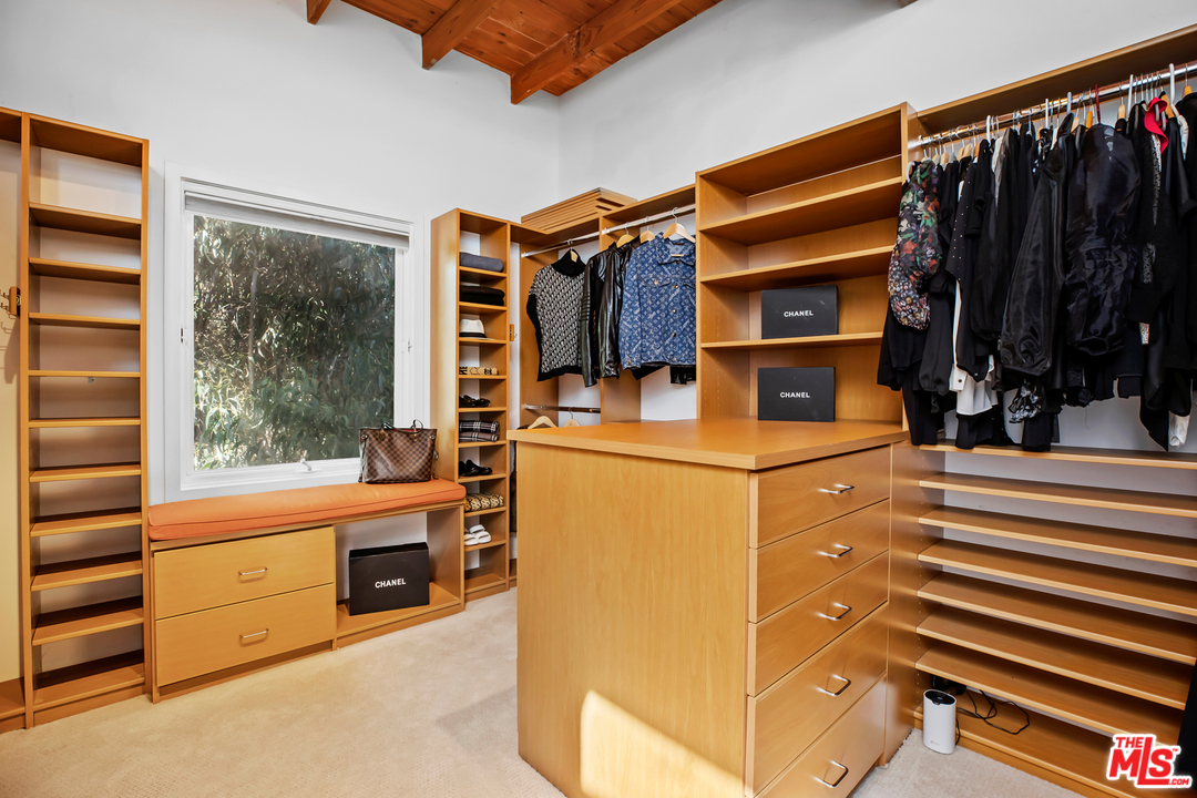 1857 North Beverly Drive Beverly Hills, CA 90210 - Photo 29 of 49 a view of walk in closet with clothes and shoes