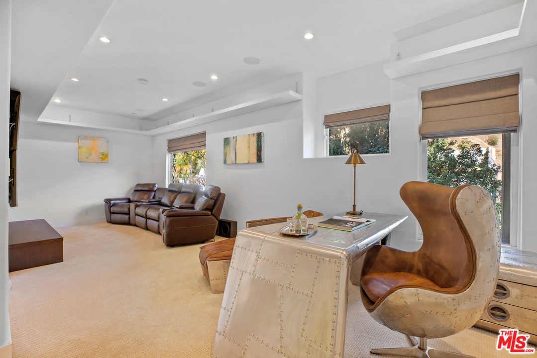 1857 North Beverly Drive Beverly Hills, CA 90210 - Photo 30 of 49 a living room with furniture and a large window