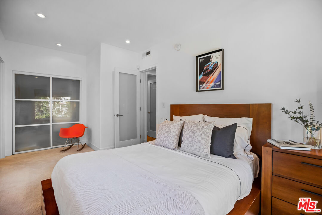 1857 North Beverly Drive Beverly Hills, CA 90210 - Photo 35 of 49 a bedroom with bed and table