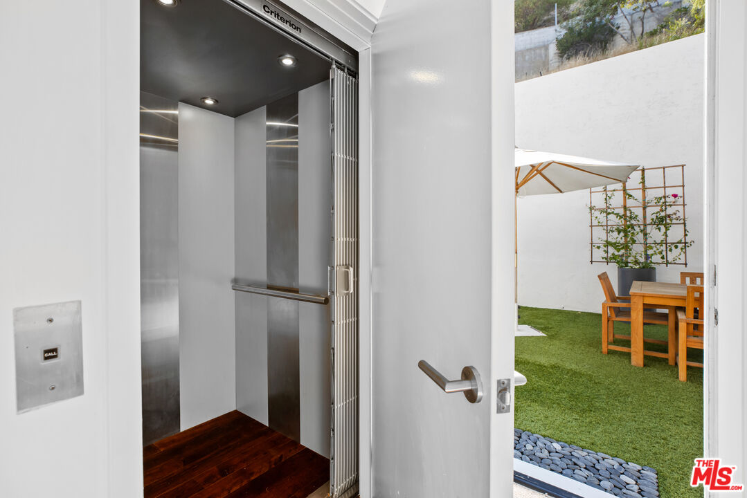 1857 North Beverly Drive Beverly Hills, CA 90210 - Photo 41 of 49 a view of a hallway with wooden floor and a bathroom