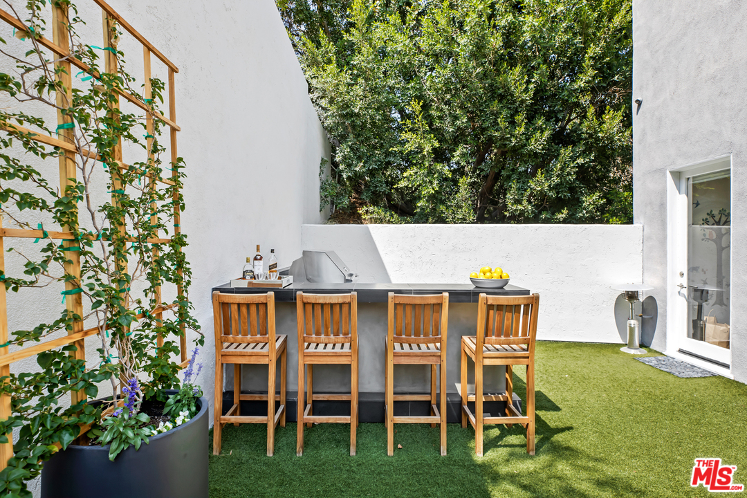 1857 North Beverly Drive Beverly Hills, CA 90210 - Photo 42 of 49 a view of a chairs and table in the patio