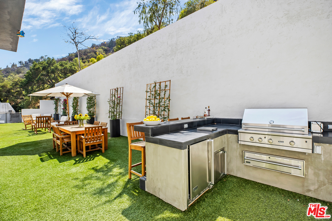 1857 North Beverly Drive Beverly Hills, CA 90210 - Photo 45 of 49 a utility room with a stove and a table