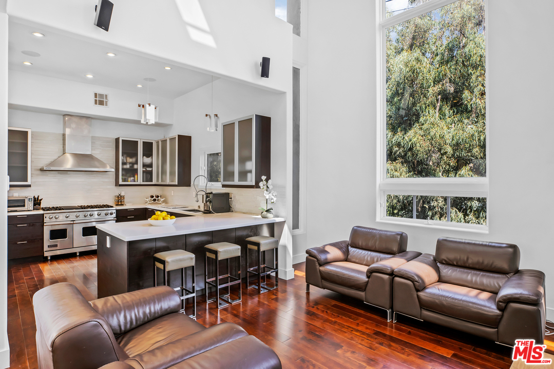 1857 North Beverly Drive Beverly Hills, CA 90210 - Photo 6 of 49 a living room with furniture kitchen view and a large window