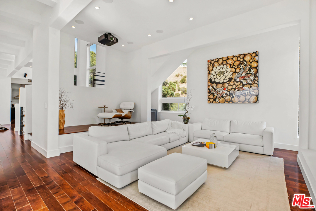1857 North Beverly Drive Beverly Hills, CA 90210 - Photo 7 of 49 a living room with furniture and a large window