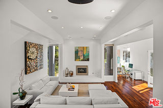 1857 North Beverly Drive Beverly Hills, CA 90210 - Photo 9 of 49 a living room with furniture and a rug