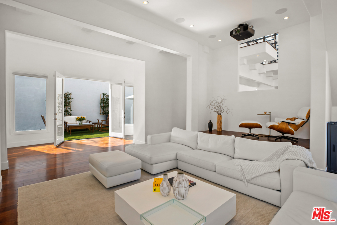 1857 North Beverly Drive Beverly Hills, CA 90210 - Photo 10 of 49 a living room with furniture and a large window