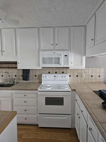 a kitchen with cabinets appliances and a sink