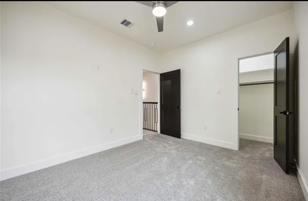 an empty room with windows and closet