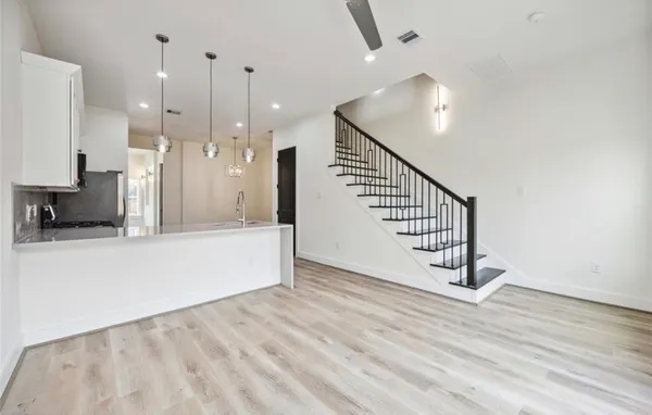 a view of a room with wooden floor and staircase