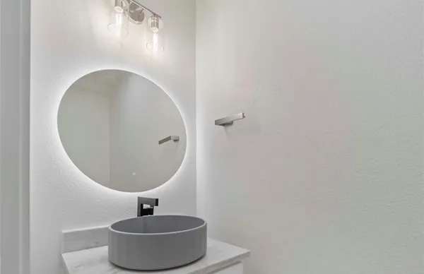 a bathroom with a sink and mirror