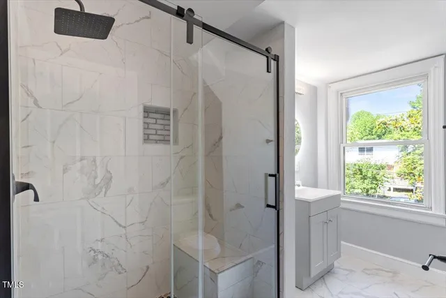 a bathroom with a shower and a window