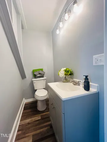 a bathroom with a sink toilet and a mirror