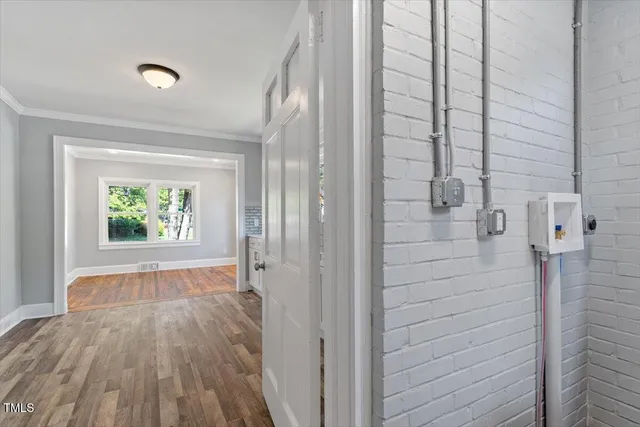 a view of hallway with wooden floor and window