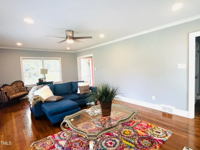 a living room with furniture and wooden floor