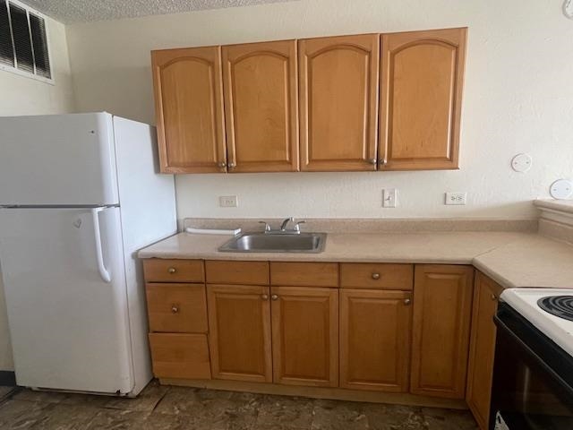 111 Kahului Beach Road, Unit D410 Kahului, HI 96732 - Photo 2 of 14 a kitchen with stainless steel appliances granite countertop a refrigerator a sink and white cabinets