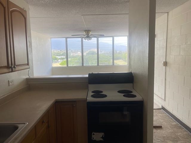 111 Kahului Beach Road, Unit D410 Kahului, HI 96732 - Photo 4 of 14 a kitchen with a window wooden floor and a sink