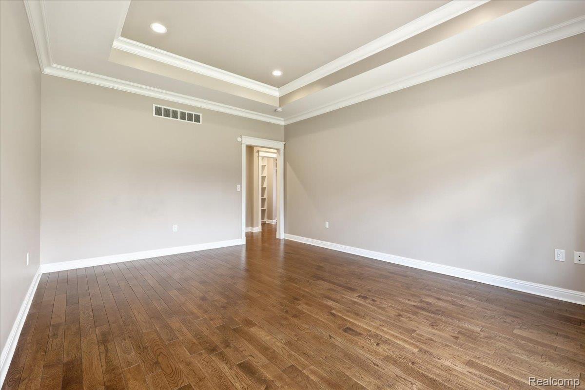 35339 West 13 Mile Road Farmington, MI 48331 - Photo 24 of 72 Primary bedroom with a tray ceiling, dark wood-type flooring, crown molding, and recessed lighting