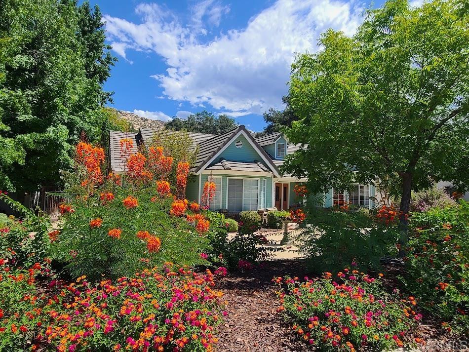 25084 Pappas Road Ramona, CA 92065 - Photo 2 of 58 a view of a garden with flowers and trees