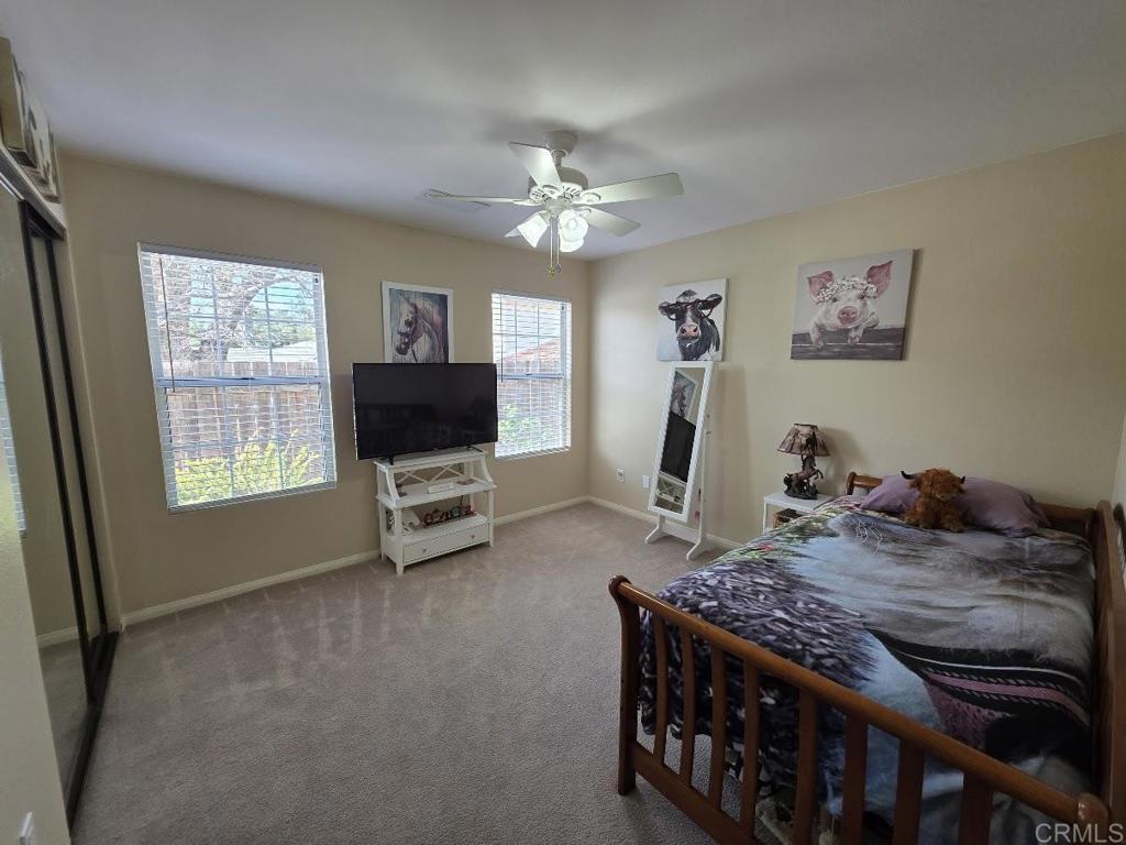 25084 Pappas Road Ramona, CA 92065 - Photo 23 of 58 a bedroom with a bed and a flat screen tv