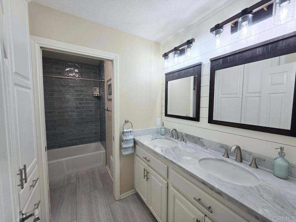 25084 Pappas Road Ramona, CA 92065 - Photo 24 of 58 a bathroom with a granite countertop sink mirror double shower and a bathtub