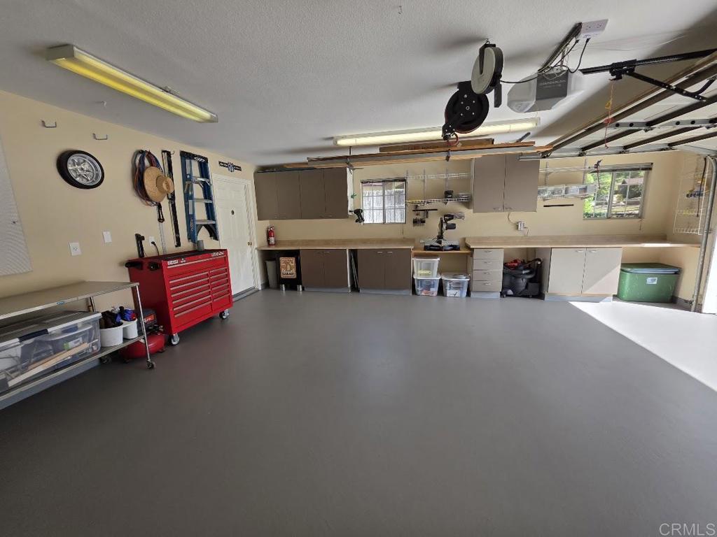 25084 Pappas Road Ramona, CA 92065 - Photo 39 of 58 a living room with furniture gym equipment and a flat screen tv