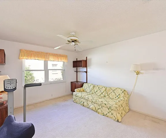 a bedroom with furniture and a window