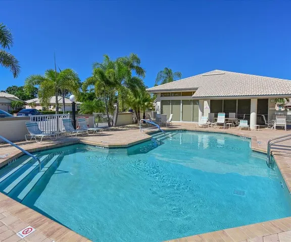 a swimming pool with outdoor seating and yard