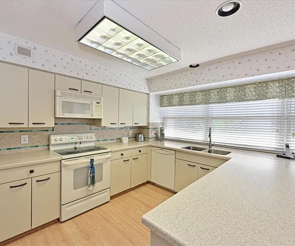 a kitchen with appliances cabinets and a sink