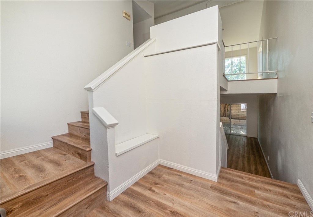 3240 Gibraltar Dr. Riverside, CA 92506 - Photo 4 of 50 at mid level entry, stairs up lead to main floor with primary suite, kitchen, living/dining & family rooms; stairs down lead to second family room, 3 bedroom, bonus room, bathroom & laundry room