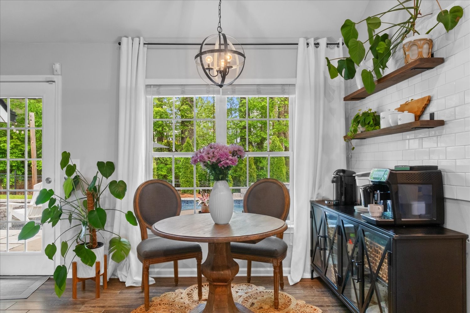 3715 Ivanora Drive Spring Hill, TN 37174 - Photo 19 of 74 a view of a dining room with furniture a potted plant and a window