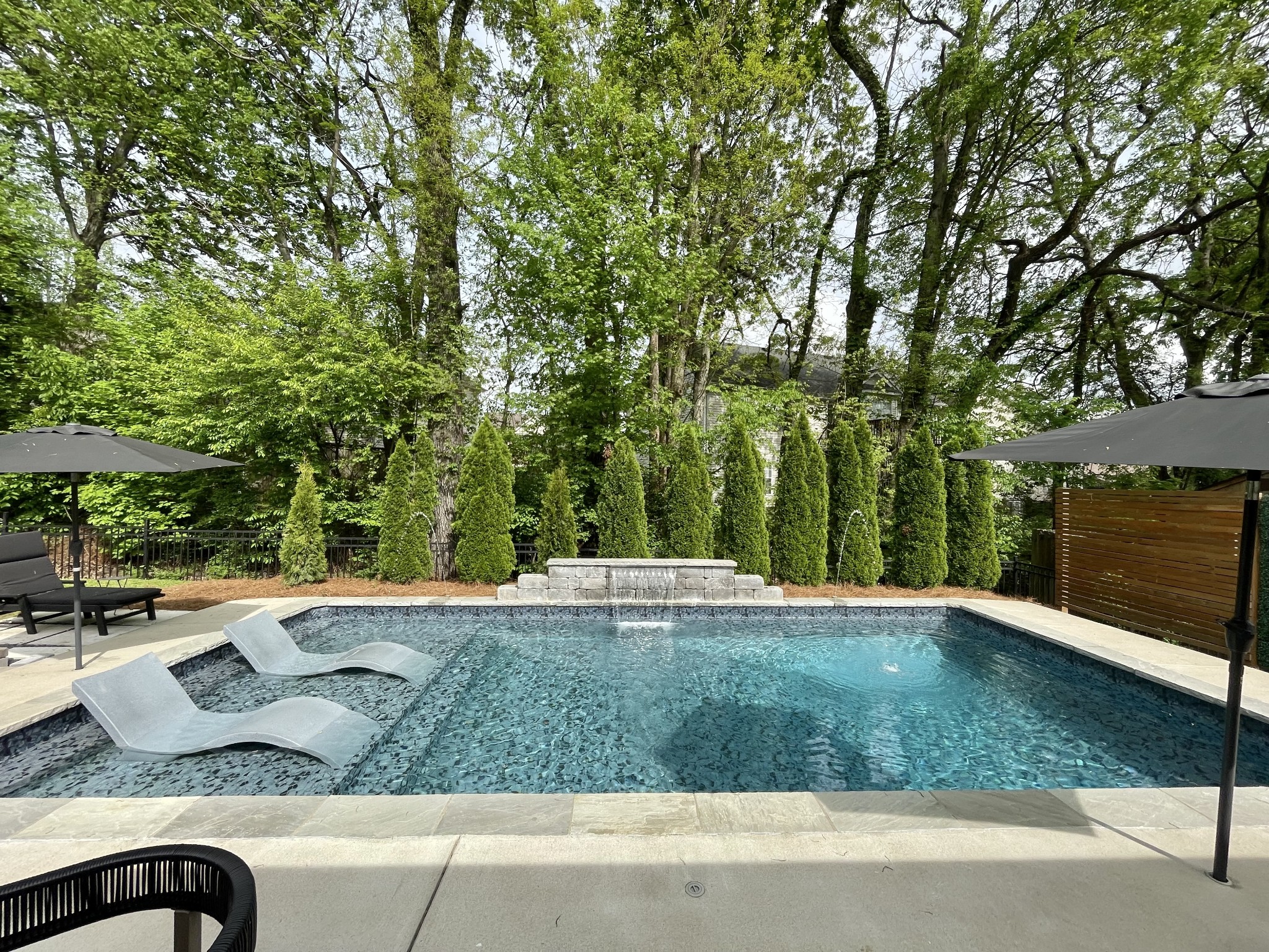 3715 Ivanora Drive Spring Hill, TN 37174 - Photo 47 of 74 a view of a backyard with table and chairs under an umbrella