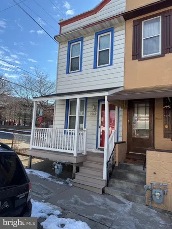 a view of a house with a bench in patio