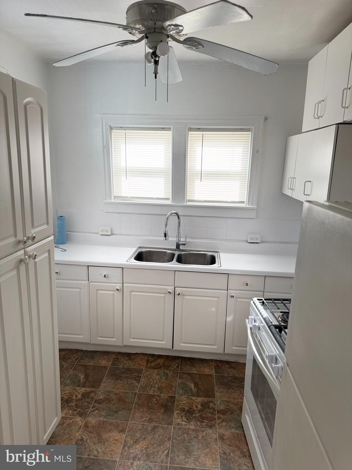 1060 Pike Street Reading, PA 19604 - Photo 6 of 11 a kitchen with white cabinets and sink