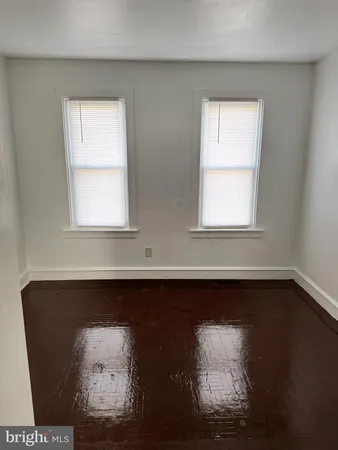 a view of a small space with wooden floor and a window